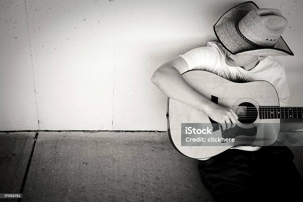 Cowboy Playing Guitar with copy space Cowboy Playing Guitar with copy spaceBlack and White image with contrast added Country and Western Music Stock Photo