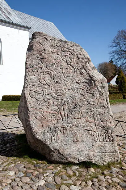 King Harald the Bluetooth runic stone c. 965 AD aa Denmarkaas abirth certificateaAThe Jelling monuments were registered on the World Heritage List because of the unique historical importance of the site.At Jelling you meet the 10th century Viking King, Gorm den Gamle (Gorm the Old) who died in 959 and Queen Thyra as well as their son Harald BlAYtand (Harald Bluetooth) who died in around year 987.The burial mounds, the runic stones and the church are markable example of Nordic pagan culture and illustrate an important role in the history of the area, a unique complex of religious and political manifestations and early Christianity in Scandinavia in the 10th century.The monuments consist of the two runic stones, the medieval church and the two burial mounds.The monuments reflect the transition from paganism to Christianity, and are referred to as Denmarkaas birth certificate, as one of the runic stones carries the oldest inscription referring to Denmark the country and its people athe DanesaA.