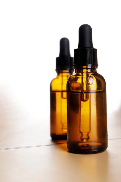 istock serum bottle with pipette reflected in mirror with white background 1711539871