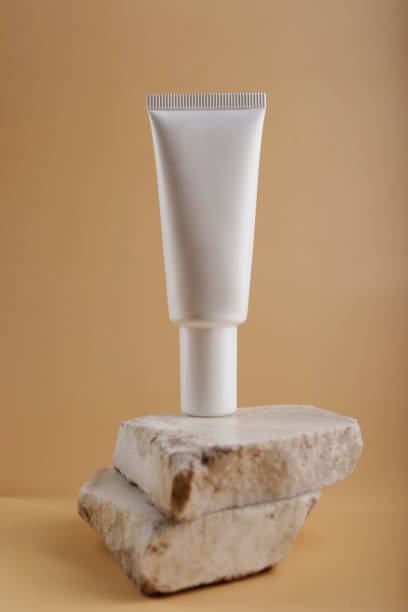 istock white cosmetic container on marble stone and nude color background 1711540393