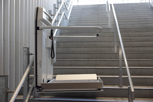 Metal staircase gray railing on concrete wall