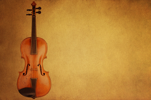 Shiny violin and bow isolated on black velvet  background with copy space