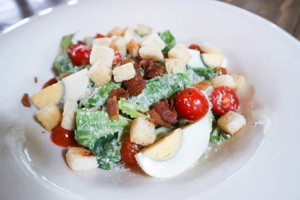 istock caesar salad or vegetable salad with bacon and boiled egg , Bread Croutons and cheese 1711543809