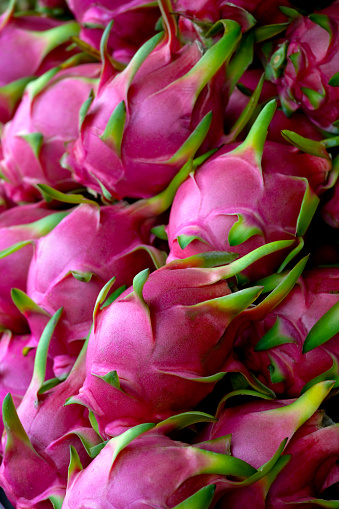 Fresh Dragon fruit for sale in a Thai market, shallow depth of field.