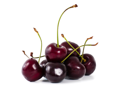 Cherry on an isolated white background. Whole and half cherries.