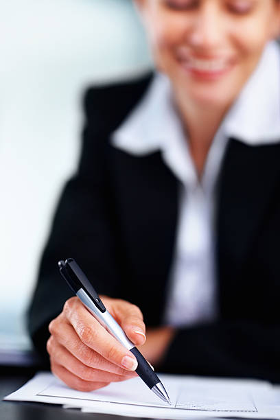 istock Business woman writing notes, focus on pen 171154935