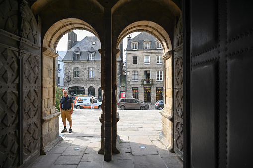 Dinan, France, September 8, 2023 - View through an archway on the Grand Rue in the medieval old town of Dinan, Brittany, France.