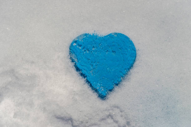 istock Blue heart shape on a white snow in winter, close up 1711549991