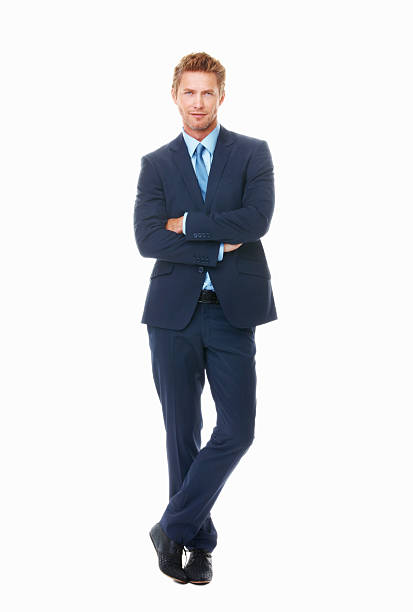Full length of successful young business man in stylish suit standing on white background with arms crossed