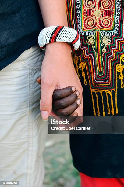 White And Black People Holding Hands Stock Photo - Download Image Now - Ethiopia, People, Charity and Relief Work