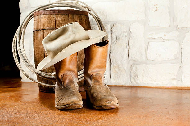istock Cowboy boots and hat. Austin sandstone background 171155393