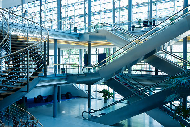 modern business building interior with stairs and escalators, blue tonedClick here to view more related images: