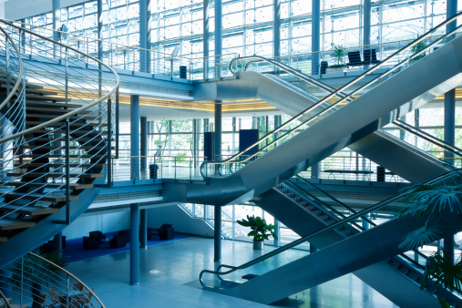 modern business building interior with stairs and escalators, blue tonedClick here to view more related images: