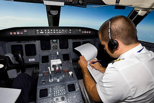 istock Young co-pilot at work in a cabin of commercial jet 171155579