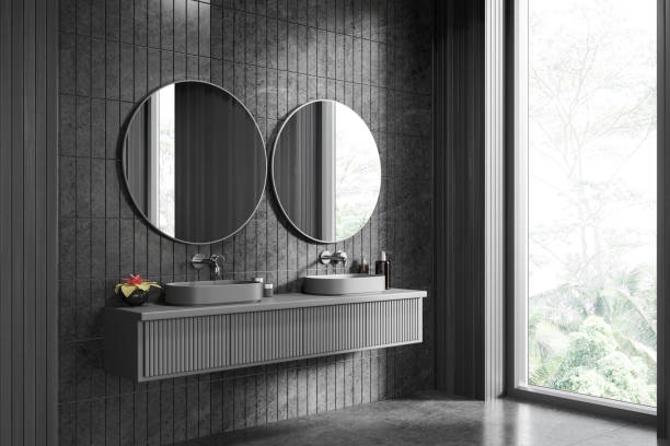 istock Dark hotel bathroom interior with double sink and vanity near window 1711556670