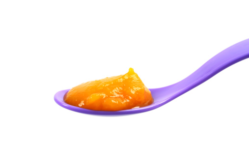 Baby Food: Pureed Pumpkin on a Spoon.