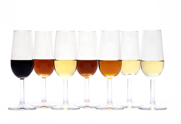 seven glasses of different sherry row of seven glasses with different flavors of Spanish sherry on isolated on white background, clipping path included sherry stock pictures, royalty-free photos & images