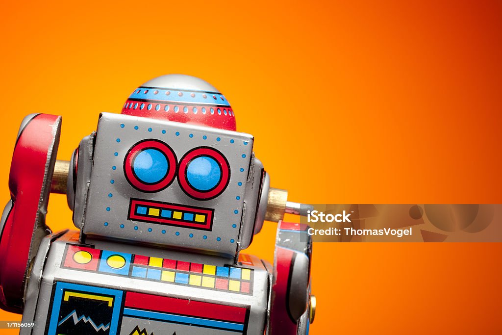 Retro tin robot portrait on orange Robot Stock Photo