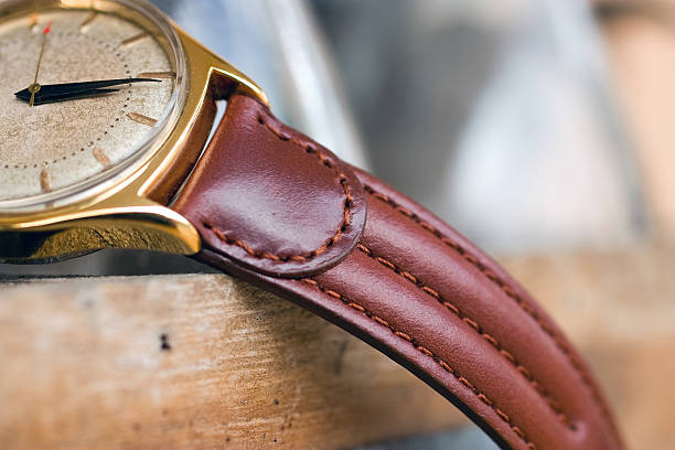 Vintage wrist watch from Swiss A golden retro wrist watch with genuine leather watchband from Swiss. swiss watches stock pictures, royalty-free photos & images