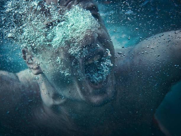 Drowning Man drowning, screaming underwater. Focus on air bubbles drowning photos stock pictures, royalty-free photos & images