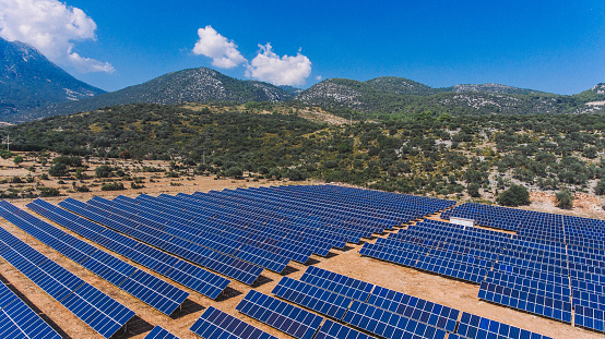 Solar panels in a forest. Solar panels on a mountain. A view of the cinematic solar panel,Solar panels in a forest. Solar panels on a mountain. A view of solar panels with mountains in the background