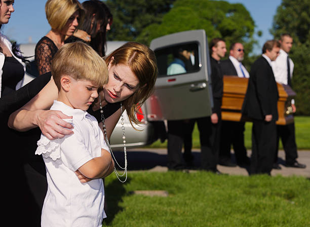 Mother and Son at a Funeral A mother comforting her son at a military funeral. child casket stock pictures, royalty-free photos & images