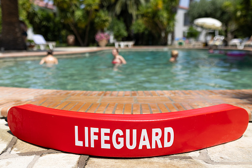 Red rescue tube against swimmers in the swimming pool