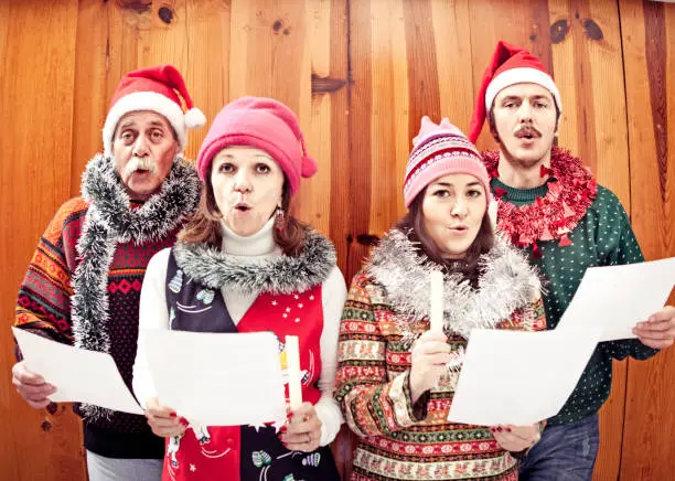 Family singing Christmas songs. Focus is on men.