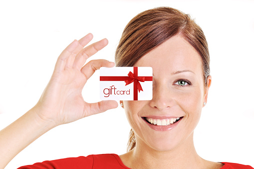 Young beautiful woman holding a gift card.