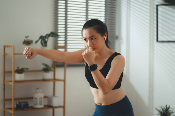 istock Asian woman doing exercise training in living room at home. 1711568761