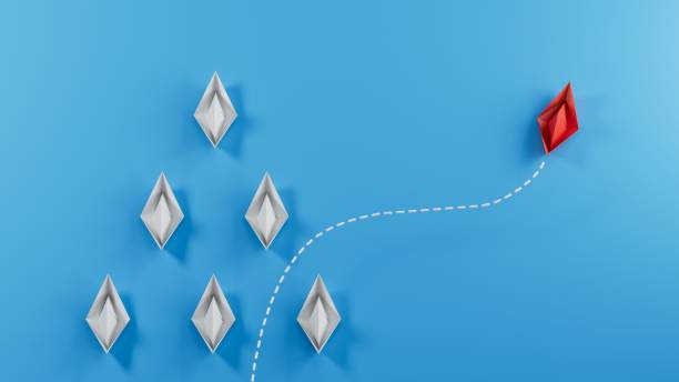 istock Think differently concept. Red paper paper boat changing direction.3D rendering on blue background. 1711579278