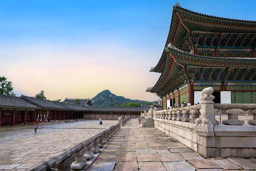 Gyeongbokgung Palace, Seoul, South Korea : June 17 2023 : Geunjeongjeon Hall in Gyeongbokgung Palace the famous landmark of South Korea before closing time with the traveler in the sunset sky