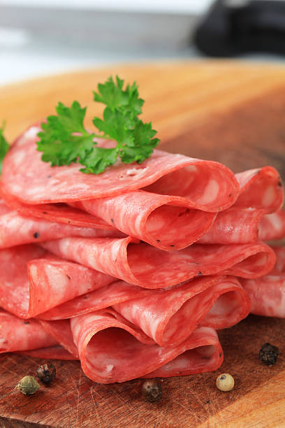 Pile of sliced salami on a cutting board