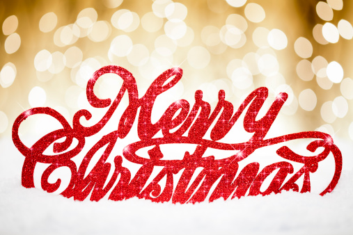 Photography of a Merry Christmas glitter text in a golden winter scene.