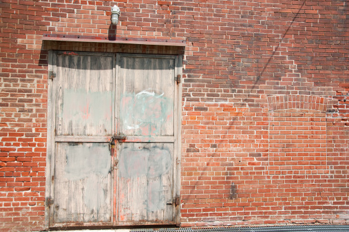 An old door on a red brick wall at the Brickworks in Toronto