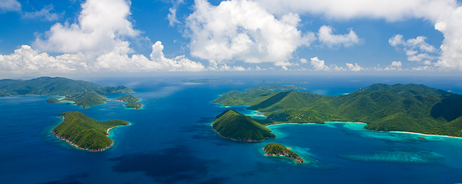 aerial panoramic shot of St. John, US Virgin Islands on the right and Tortola, British Virgin Islands on the left with Sir Francis Drake Channel in the middle