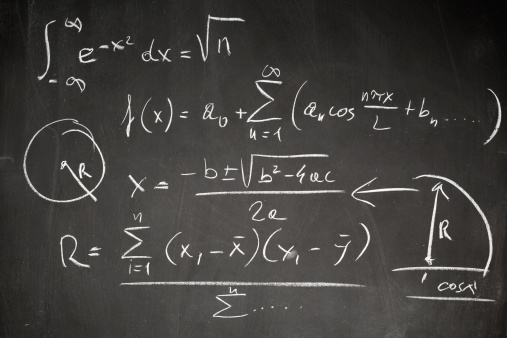 Complicated math formula written on a blackboard with white chalk