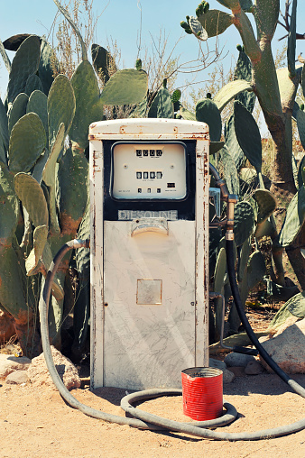 Antique rusted fuel pump amongst cactus plants in Solitaire,Namibia.