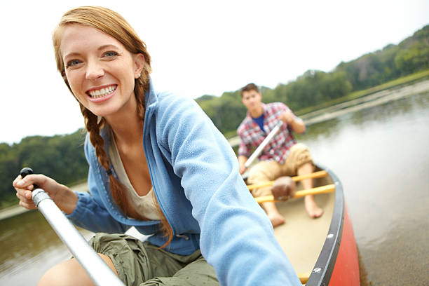 il suo tipo di vacanza preferito-copyspace - canoeing people traveling camping couple foto e immagini stock