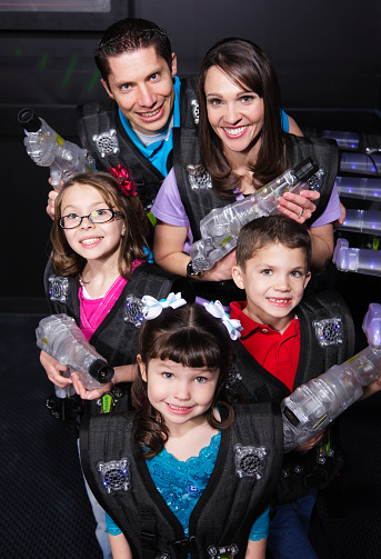 A family preparing for a game of laser tag.