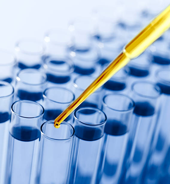 istock Droplet Falling from Pipette into Test Tube 171159383
