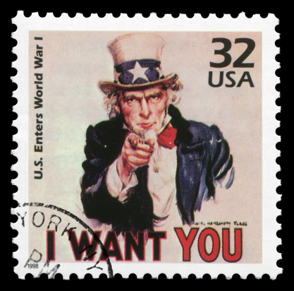 US postage stamp: US enters world war I, issued in 1998. On the painting, Uncle Sam is pointing with his hand and proclaiming: \