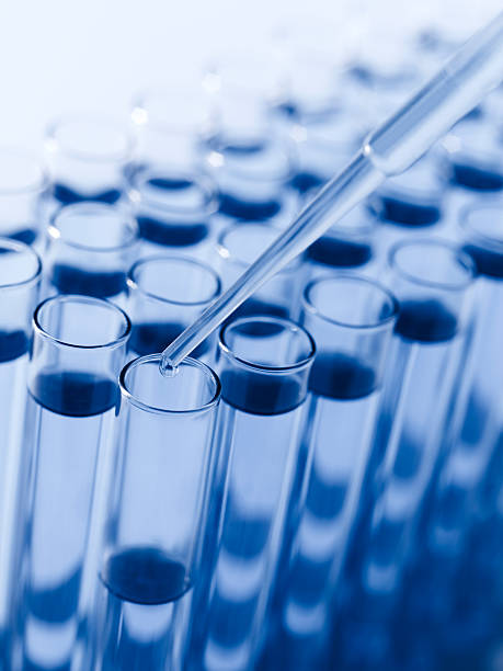 istock Droplet Falling from Pipette into Test Tube 171159608