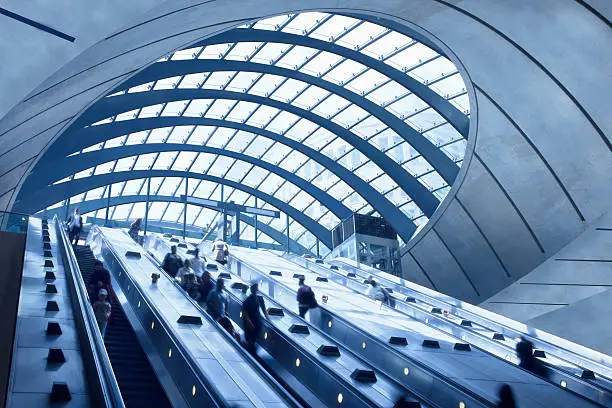 subway station with escalators and blurred people, Canary Wharf, London, UK,click here to view more related images: