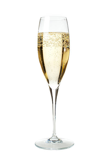 Glass of Champagne To properly welcome the New Year's Eve what's better than a flûte of sparkling and chilled French Champagne? Vertical portrait of a flûte glass full of champagne isolated on white, ideal for conveying any party related concept. champagne stock pictures, royalty-free photos & images