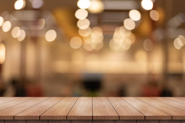 istock Empty wooden table top with lights bokeh on blur restaurant background. 1711626102