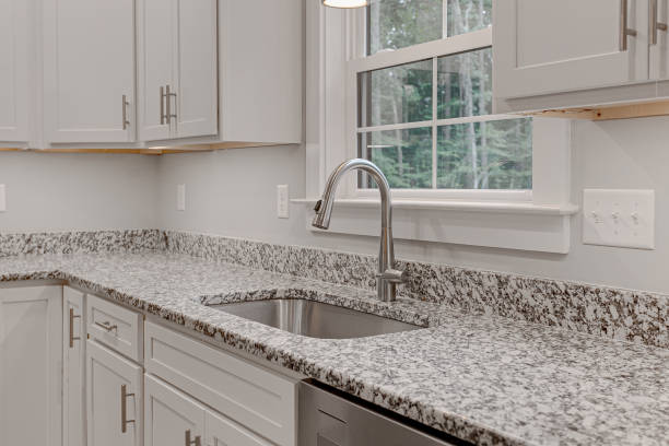 istock New Clean Modern White Kitchen Interior with Granite Stone Countertops and Cabinets 1711642001