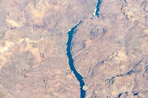 Aerial view of the Colorado River on the border between Arizona and Nevada, featuring White Rock Canyon and the Liberty Bell Arch past the Hoover Dam