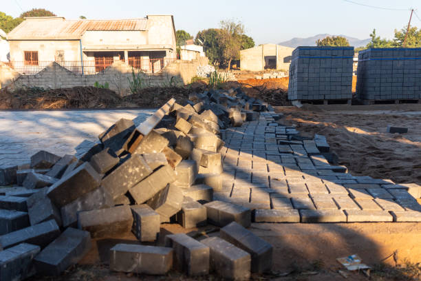 Road under construction, on a dirt road during installation of concrete pavers