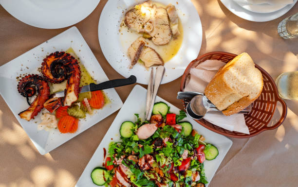 istock Grilled octopus tentacles, fish and salad with mussels. 1711740131